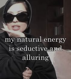 a woman wearing sunglasses with the words, my natural energy is seductive and alluring