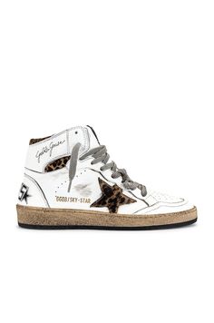 From Italy to the skateparks of Los Angeles, Golden Goose has become a world-renowned high fashion brand for luxury sneakers. Hand crafted on premium Italian leather; Golden Goose has successfully combined the relaxed vintage aesthetic with their unique 'lived in' touch. Their signature pre-scuffed style (each distressed by hand) offers a nonchalant attitude that embodies 'perfect imperfection' for a touch of life, comfort and fashion forward designs.Leather upper with rubber sole.  Made in Ital Golden Goose Sky Star, Black Leo, Perfect Imperfection, High Fashion Branding, Fur Heels, Luxury Sneakers, Star Sneakers, Swag Shoes, Hot Shoes