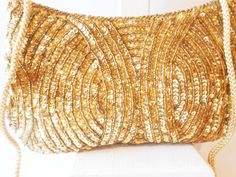 "A gold beaded evening bag with lots of glamour. This vintage bag has a background of gold satin with gold sequins and beads. It has a snap closure. The sequin evening bag has a gold taffeta interior and includes one small pocket. This is a glamorous gold beaded clutch bag plus it includes a gold cord strap to wear on your shoulder or cross body. This gold bead clutch has a lot of sparkle. This gold bead bag has lots of glamour just for you. A perfect party bag or cocktail purse. MATERIAL: Sequi Purple Clutch, Beaded Clutch Bag, Purple Handbags, Bead Bag, Vintage Evening Bags, Wedding Bags, Beaded Evening Bags, Glam Party, Gold Bag