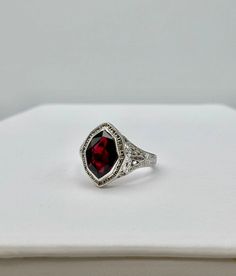 This stunning vintage ring features intricate filigree work and the most unique shaped stone. The stone's coloring resembles a garnet with its deep and rich red hue. This ring is a size 6.25. Gold Garnet Ring, Garnet Ring Vintage, Colored Stone Rings, Colored Stone, Garnet Ring, Garnet Rings, Vintage Ring, Ring Vintage, Stone Ring