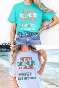 pregnant woman wearing a miami dolphins inspired pregnancy announcement shirt Football Season Fan Event Tops With Letter Print, Sports Fan Tops With Letter Print For Fan Events, Short Sleeve Tops For Fan Apparel, Short Sleeve Tops For Fan Gatherings, Fun Short Sleeve T-shirt For Game Day, Pre-shrunk Fun T-shirt For Game Day, Fun Pre-shrunk T-shirt For Game Day, Sports Fan Slogan Tops For Game Day, Game Day Sports Fan Slogan Tops