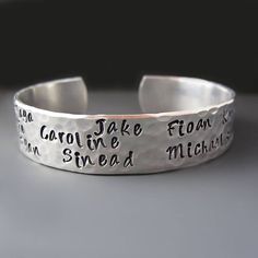 Personalized Mother's Cuff * Children's Names * Hand Stamped Give a one of a kind beautiful handcrafted bracelet with the names of your children or grandchildren. Include your own personal message on the inside. WHAT TO INCLUDE WITH YOUR ORDER: 1. The NAMES you want stamped on the cuff. All names will be stamped on the OUTSIDE of the cuff unless other instructions are provided. ( MAXIMUM OF 10 Names) CUFF DETAILS: * The TOP of the cuff is stamped with your choice of names. This cuff can hold app Personalized Adjustable Cuff Bracelet, Gift Cuff Bangle With Stamped Detail, Stamped Bangle Cuff Bracelet Gift, Hand Stamped Bangle Cuff Bracelet For Gift, Stamped Cuff Bracelet As Gift, Stamped Cuff Bracelet Gift, Handmade Adjustable Name Bracelet For Wedding, Adjustable Hand Stamped Bangle For Anniversary, Adjustable Stamped Bangle For Anniversary