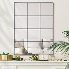 a living room with a fireplace, mirror and potted plant