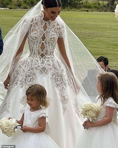 the bride and her flower girls are getting ready to walk down the aisle