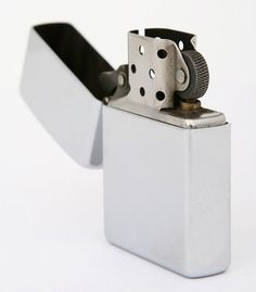 a white lighter with a black handle on the top and bottom part is shown in front of a white background