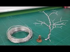 a wire tree is sitting next to a piece of wire