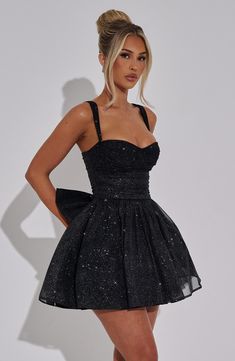 Time to glow in Polly, the sparkliest mini to wear for those special occasions. We love the cinched waist and contrasting full skirt, with detachable bow to the back to finish the look. Style yours with glowing makeup and heeled mules. 



Colour: Black Sparkle.

Sparkle stretch mesh fabric.

Fully lined.

Underwired cups.

Ruched details.

Tulle attached to lining for added volume.

Full skirt with gathering at waist.

Detachable bow detail to back.

Invisible zipper fastening.

Mini length.

 Size: XS, S, M, L, XL, XXL Mini Hoco Dresses, Black Dress Sparkle, White Dress Spring, Midi Dress Wedding Guest, Dress Sparkle, Black Sparkly Dress, Sparkly Mini Dress, Stretch Mesh Fabric, Maxi Dress Sale