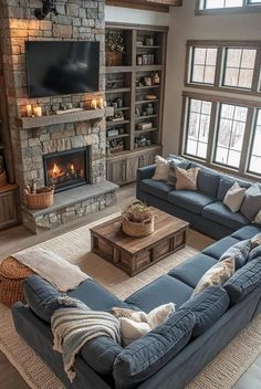 a living room filled with furniture and a fire place in the middle of the room