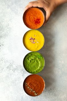 three bowls filled with different colored sauces