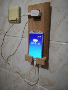 an electronic device is plugged into a wall charger with a phone attached to it