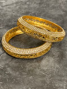 Gold plated bangle set Aruna . Comes in pair.Silver Rhinestone work around . Gold Bollywood Bangle For Rituals, Heavy Bollywood Gold Bangle, Gold Bollywood Bangle With Intricate Design, Gold Bollywood Bangle For Parties, Gold-plated Bollywood Bangle, Gold Plated Bangles, Bangle Set, Gold Bracelet, Gold Plate