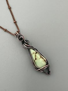 a necklace with a green stone in the center