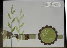 a close up of a greeting card with a bow on the front and green leaves on the back