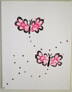 two pink butterflies with black dots on white paper