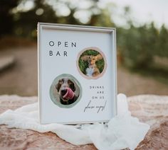 an open bar sign with a dog's face and tongue sticking out from it