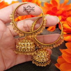 "Gorgeous, handcrafted gold & light orange meenakari waali jhumkis! The earrings are 3 \" long & 2 \" wide. Picture is taken in natural room light. Please contact if you have any questions. Thanks! Color, shades, texture displayed may slightly vary from the actual product due to digital image limitations. We request you to consider these minor variations. Please expect the possibility of some slight imperfections when buying hand made jewelry. If you have any questions, please contact us." Festive Round Danglers For Puja, Gold Meenakari Chandbalis For Puja, Round Meenakari Jhumkas For Festivals, Gold Meenakari Danglers, Round Tilla Jhumkas For Puja, Meenakari Jhumkas For Festivals, Cutdana Jhumkas For Puja, Diwali Gift Meenakari Hoop Earrings, Orange Jewelry For Diwali Puja