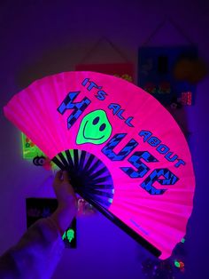 a person holding a neon pink fan with the words it's all about my friends