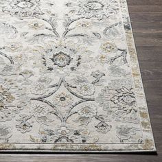 a large rug with an ornate design on the top and bottom in grey, yellow and white colors