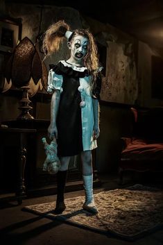 a creepy woman dressed in blue and black