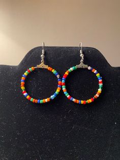 Bohemian styled hoop earrings.  Made with multicolored seed beads.  Multicolored to go with any outfit! * All materials were cleaned and sanitized prior to use and kept in a clean smoke-free environment. Comes packaged in a mesh drawstring bag. Bohemian Heishi Beads Small Hoop Earrings, Bohemian Heishi Beads Hoop Earrings, Adjustable Multicolor Bohemian Hoop Earrings, Bohemian Hoop Beaded Earrings With Heishi Beads, Bohemian Heishi Beads Earrings For Beach, Bohemian Heishi Beaded Hoop Earrings, Bohemian Hoop Earrings With Heishi Beads, Bohemian Small Hoop Beaded Earrings With Dangling Beads, Bohemian Small Hoop Heishi Bead Earrings