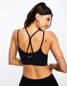 Sportswear by Nike Training Supportive stuff Layered design Scoop neck Strappy, racer back for unrestricted movement Nike logo print on back Pull-on style Sporty T-back Crop Top For Workout, Sporty T-back Sports Bra For Gym, Black Sports Bra With Built-in Bra And Medium Support, Sports Bra With Mesh Back And Cross Back, Sports Bra With Built-in Bra For Sports Events, Cross Back Sports Bra With Mesh Detail, Sports Activewear With Mesh And Cross Back, Sports Activewear With Mesh Cross Back, Sporty Cross Back Activewear For Training