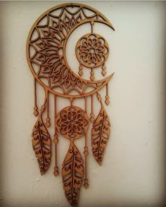 an intricate wooden dream catcher hanging on the wall