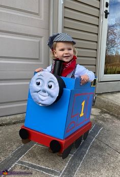 a little boy in a thomas the tank engine costume