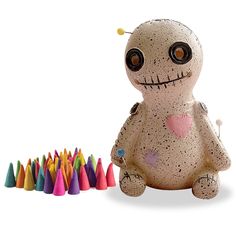 a stuffed animal with lots of colored crayons next to it