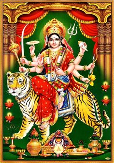 the hindu goddess sitting on top of a tiger