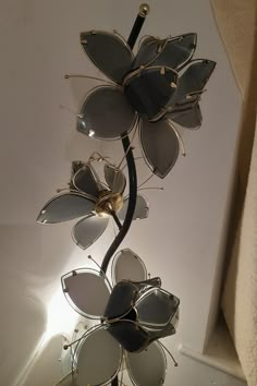 a pair of sunglasses is hanging from a metal flower with glasses attached to the stems