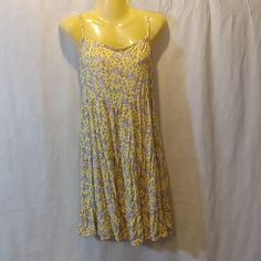 Tag Size Medium. Style Rw520695. Yellow Purple Multicolored Floral Print. Tiered Gathered Skirt. Flat Armpit To Armpit 16 Inches, Has Elastic Across Back. Length From Shoulder 34 Inches. Adjustable Straps. 100% Rayon. New With Tag As Shown. Yellow Flowy Sleeveless Sundress, Casual Yellow Printed Sundress, Spring Yellow Printed Sundress, Yellow Floral Print Sundress For Daywear, Casual Yellow Mini Dress For Daytime, Yellow Flowy Sleeveless Mini Dress, Flowy Sleeveless Yellow Mini Dress, Yellow Printed Mini Dress For Beach, Yellow Casual Mini Sundress