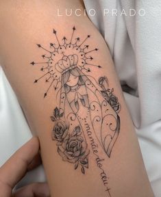 a woman's arm with tattoos on it and roses in the center, next to an arrow