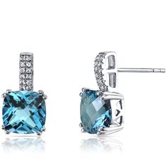 A Swiss affair Inspired by soft, blue skies and charming Swiss blue lakes. These graceful earrings feature cushion cut Peora natural Swiss Blue Topaz gemstones in 14K white gold. Our natural Swiss Blue Topaz gemstones are a unique gift from nature. By cutting them in a way that respects the rough's natural radiance, we ignite their inherent intensity and maximize their brilliance to deliver on our signature Peora standard. Handcrafted in pure 14K white gold goodness, these earrings have been carefully coated in an elegant rhodium finish. Our artisans are expertly trained in this process which fortifies the earring's strength, shine and brilliance. Shopping for birthdays, bridal parties or other occasions? Our concierge stylists are here to help with all of your jewelry questions. Each purc London Blue Topaz Earrings, White Gold Drop Earrings, Jewelry Questions, Blue Topaz Earrings, Ruby Emerald, Sparkle Earrings, Topaz Earrings, Pacific Blue, Swiss Blue Topaz