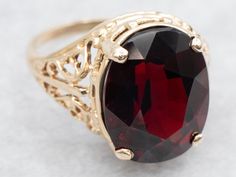 Elevate your style with this ring. The exquisite oval cut garnet is set in a delicate filigree shank, creating a stunning solitaire cocktail ring. Make a statement with this elegant piece that exudes sophistication! Metal: 10K Yellow GoldGem: Garnet 12.65 CaratsGem Measurements: 15.3 x 12.2 mm, OvalRing Size: 8Marks: "A10K" Stamped on the inside band Garnet And Gold, About Page, Oval Ring, Oval Rings, Garnet Ring, January Birthstone, Gold Filigree, Garnet Rings, Cocktail Ring