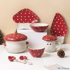 red and white polka dot ceramic kitchenware set with pine cone decoration on the table