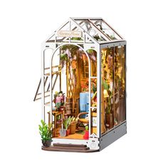 a doll house with a greenhouse on the front and side doors open to show it's interior