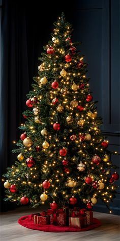 a christmas tree with lights and presents on the floor in front of a black wall