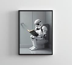 a storm trooper reading a book while sitting on a toilet