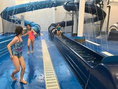 two girls are playing in the water slide