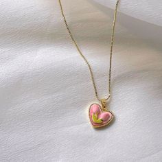 Trendy Pink tulip flower heart shaped pendant charm necklace, 14K real gold plated chain. Crafted from high-quality materials, this stunning necklace features a delicate heart-shaped pendant adorned with a beautiful pink tulip motif, symbolizing love, beauty, and new beginnings. Cute girly aesthetic, y2k layering necklace choker. Exquisite statement necklace to elevate your fashion style. 💎 Features: ♥ Handmade jewelry ♥ Finish Tone: Finest 14K gold plated | Pink ♥ Approximate Measurements: - Length: 18" with 2" adjustable - Pendant Width: 0.5" ♥ Nickel/Lead Free, Hypoallergenic, good for sensitive skins 🎁 Packing & Shipping: ♥ All our jewelry will be shipped with beautiful gift wrap packaging ♥ Handwrite gift notes/cards available upon request ♥ SAME DAY& FREE US Domestic Shipping avail Cheap Pink Heart Charm Necklace, Trendy Heart Necklace With Clavicle Chain For Valentine's Day, Trendy Valentine's Day Heart Necklace With Clavicle Chain, Trendy Heart Pendant Necklace For Valentine's Day, Trendy Heart Necklace With Heart Beads Pendant, Trendy Double Heart Clavicle Necklace, Trendy Valentine's Day Pendant Jewelry, Trendy Double Heart Clavicle Chain Necklace, Trendy Heart Pendant Jewelry With Heart Print