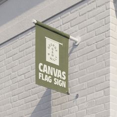 a sign on the side of a building that says canvas flag sign hanging from a pole