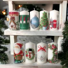 christmas candles are lined up on a shelf