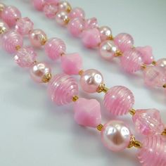 Vintage bead necklace is a nice long length with two strands of varied shapes and sizes of pink beads.  Gold filigree bead caps and tiny gold glass spacer beads.  A beautiful mid-tone pink perfect for spring and summer wear.  Closes with a hook closure marked "Germany" (I think the hook could be a replacement but it functions as it should and is as found).  In very good condition.Find lots more vintage jewelry at Purple Daisy Jewelry!http://www.etsy.com/shop/purpledaisyjewelryThanks a bunch for Pink Single Strand Beaded Necklaces For Jewelry Making, Pink Multi-strand Faceted Beads Jewelry, Pink Beaded Double Strand Jewelry, Pink Double Strand Beaded Jewelry, Pink Multi-strand Jewelry With Faceted Beads, Pink Adjustable Beaded Necklaces For Costume Jewelry, Pink Double Strand Beaded Necklaces As Gift, Pink Double Strand Beaded Necklace For Gifts, Pink Double Strand Beaded Necklace As Gift