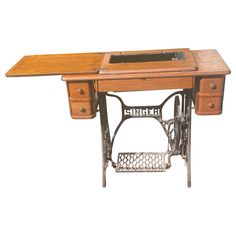 an antique sewing machine with wooden table and drawers on it's legs, in front of a white background