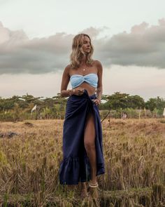 The embodiment of summer, this lightweight slik wrap skirt is printed with the prettiest floral pattern in a rainbow of happy colors. Tie it over a bodysuit, mix it or match it with our too cute Bia bandeau tops and the matching easy Brizo top. Style it wrapped or ruched. There’s no going wrong here. Color: Navy 100% Thai Silk Long, flowing silhouette Graceful understated ruffle Long soft tie for multiple wrap options Ruffle length 12.5” Overall length 43” Dry clean or gently cold water hand was Luxury Resort Wear, Ruffle Maxi Skirt, Bandeau Tops, Thai Silk, Wrap Maxi Skirt, Silk Taffeta, Silk Wrap, Happy Colors, Sustainable Fabrics