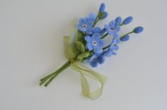 a bouquet of blue flowers on a white surface