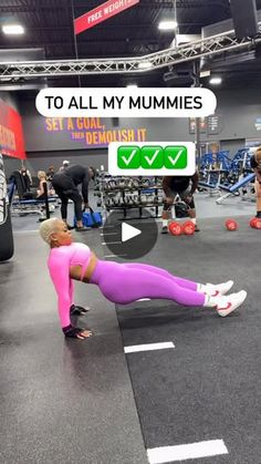 a woman doing push ups in a gym