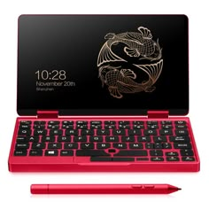 a red laptop with a dragon on the screen and a black keyboard next to it