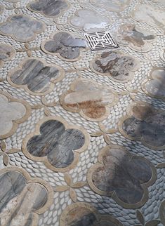 the floor is made out of stone and has circular designs on it's sides