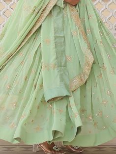 Introducing our stunning "precious pista green sequins georgette engagement wear anarkali gown," the perfect outfit for your special occasions. This exquisite gown comes in a beautiful pista green color with intricate zari embroidery and sequin work, adding a touch of elegance and glamour to your look. The gown is fully stitched and available in sizes ranging from XS to XXL, ensuring a perfect fit for every body type. With a 3.5-meter flair and a length of 56 inches, this gown is sure to make yo Pista Green Georgette Anarkali Set With Traditional Drape, Pista Green Floor-length Sharara For Designer Wear, Floor-length Pista Green Sharara For Designer Wear, Designer Pista Green Floor-length Sharara, Designer Floor-length Pista Green Sharara, Pista Green Floor-length Anarkali Set With Zari Work, Bollywood Style Pista Green Georgette Anarkali Set, Pista Green Semi-stitched Floor-length Anarkali Set, Pista Green Floor-length Sharara With Gota Work